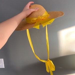 Formal hat with yellow bow.